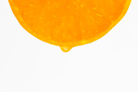 Section orange with drop of orang juiceの写真素材