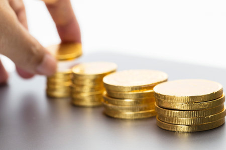 Hand stacking gold coin
