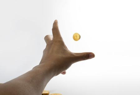 Stretching hands to grab gold coin first person point of view の写真素材