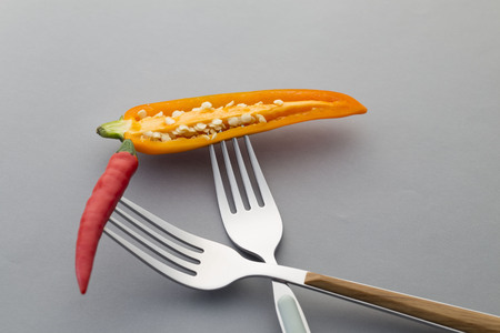 Slice Yellow Chili pepper on a forkの写真素材