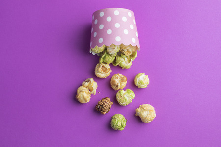 various tastes homemade popcorn on pink backgroundの写真素材