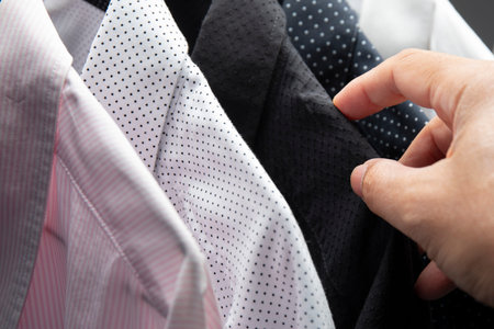 Men select new shirt in shopping mall