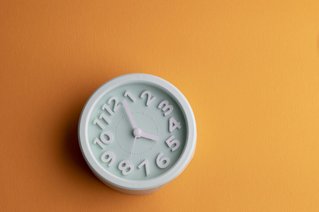 Alarm clock on yellow surfaceの写真素材