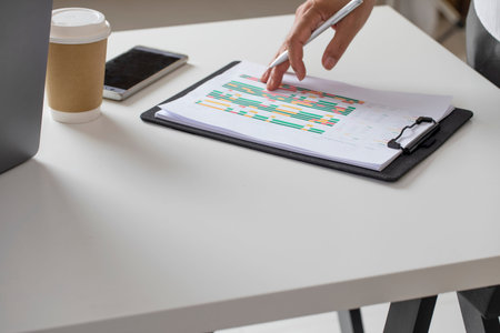 Businessman checking project timeline on paper