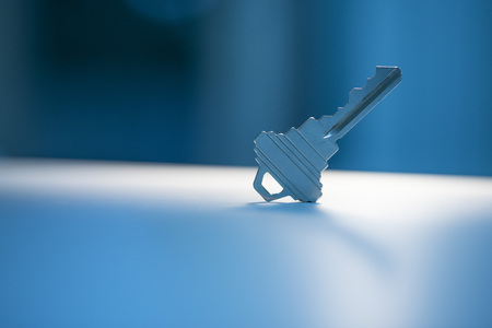 Metal key on the table with environment lightingの写真素材