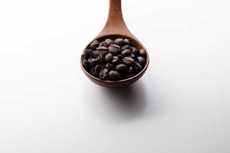 Coffee bean in wooden spoonの写真素材
