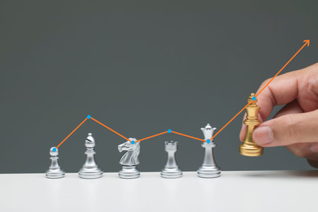Hand picking up chess king, growth business concept