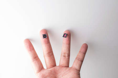 Small Digital camera lens and CCD on fingerの写真素材