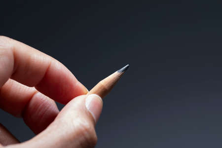 Hand holding wooden pencilの写真素材