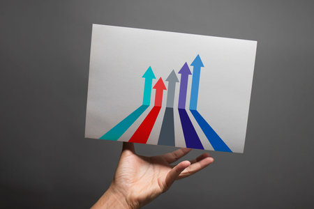 Rech out to grab the paper with arrow up to growth successの写真素材