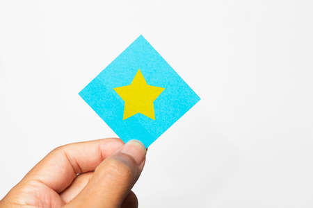 Hand holding paper with stars showing satisfaction.の写真素材
