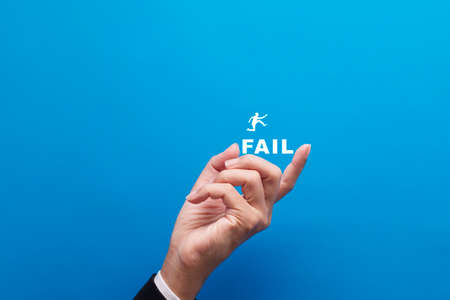 Businessman jumping over fail word, Failure or Success conceptの写真素材