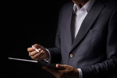 Businessman working with modern digital tablet, concepts representing planning, growth, and successの写真素材