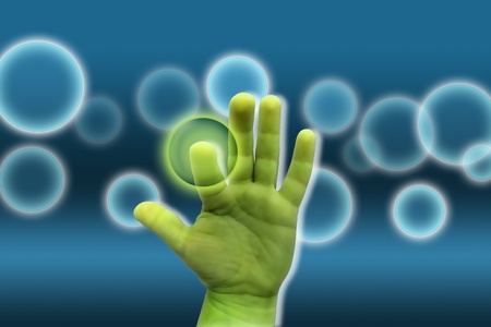 green hand on a blue background pressing magic bubbleの写真素材