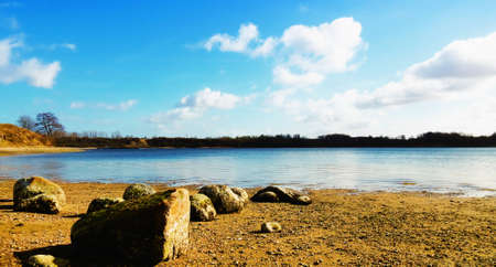 A few stones on a deserted beach at sunset - a few stones on a deserted beach at sunsetの写真素材