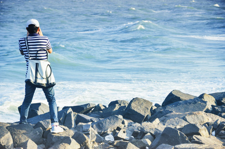 man takes photo at the beach,Chennai Indiaの写真素材