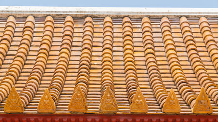 Thai temple roof with thai angels relief detail on ceramic roof.