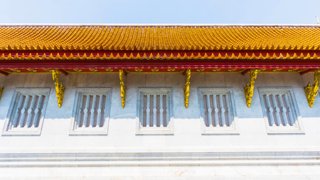 Thai temple ceramic roof with Thai style building facade and windows. Bangkok Thailand.の写真素材