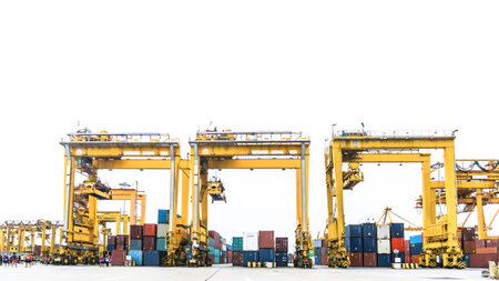 Containers wharf and container cranes in a major port with the containers ship behind.