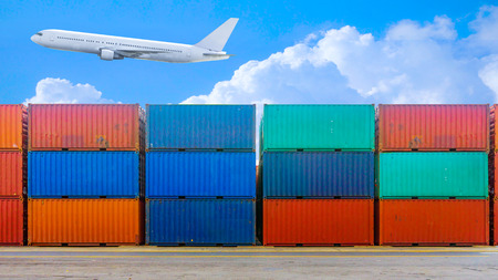 Business and logistics. Cargo transportation and storage. Equipment containers with air plane and blue sky.の写真素材