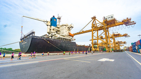 Bangkok, Thailand 29 May 2016 : At Port Authorrity of Thailand with the container ship and the tower crane on the habour at the Chao Phraya River in Khlong Toei District, take on Sunday workingのeditorial素材