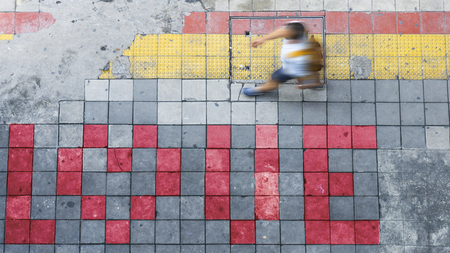 Aerial view and top view with blur man is walking in Business area with pedestrian and red and yellow block walkwayの写真素材