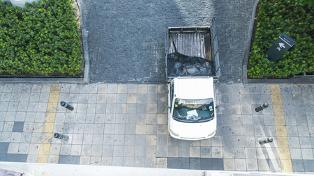 the top aerial view of people walk on the city pedestrian walkway of the entrance to street building with the landscape of green space of trees and shrub.のeditorial素材