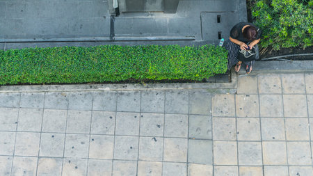 the top aerial view of people walk on the city pedestrian walkway of the entrance to street building...