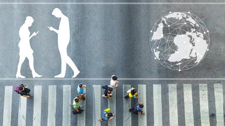 the top view of group people walk on crosswalk pedestrian walkway with the white signage symbol of people walk and world on the roadのeditorial素材