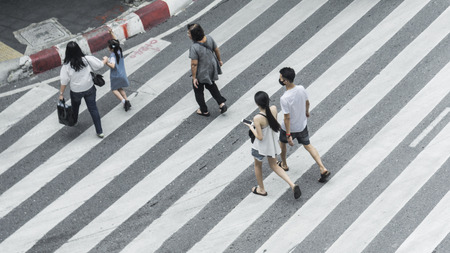 Crowd of people and group of family with child walk on street pedestrian crossroad in the city street ,from top view ,bird eye view.の写真素材