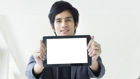 the man holds the white empty screen tablet device.の写真素材