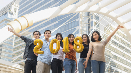 people stand in feeling happy with number balloon 2018の写真素材