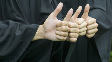 people with black graduation gowns thump upの写真素材