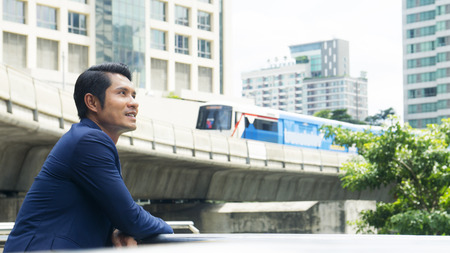 business man stand with feeling confident and freedom at outdoorの写真素材