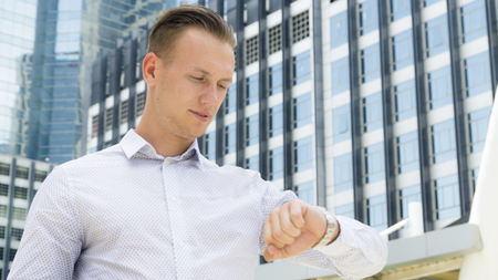 smart business confident man stand at  outdoor public space with modern buildingの写真素材
