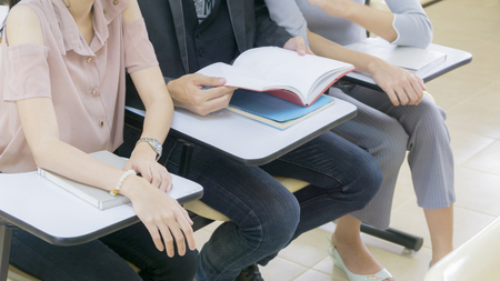 group student read book and sit in classroomの写真素材