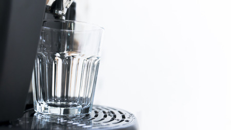 Cup of coffee with drop of water from bean to coffee machine in cappuccino and espresso styleの写真素材