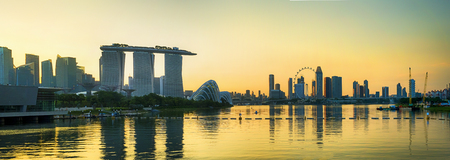 Business city district of Singapore Skyline with modern tower building skyscrapers lighting on twilight colorful of sky with cloud and reflection in water river. Popular travel destination.のeditorial素材