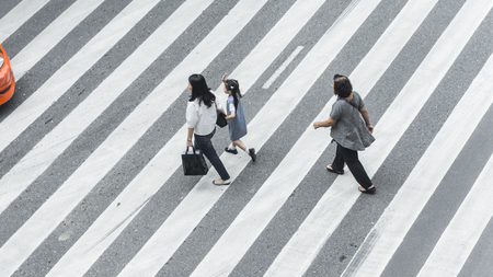 Crowd of people and group of family with child walk on street pedestrian crossroad in the city street ,from top view ,bird eye view.のeditorial素材