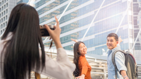 business woman hold camera to shoot the traveler couple people at urban city and modern building....