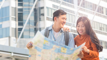 traveler couple people use generic local map and talk at urban city. Honeymoon trip, holiday...