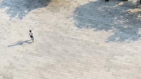 Crowd of people walk on open space concrete pavement from top view ,bird eye viewの写真素材