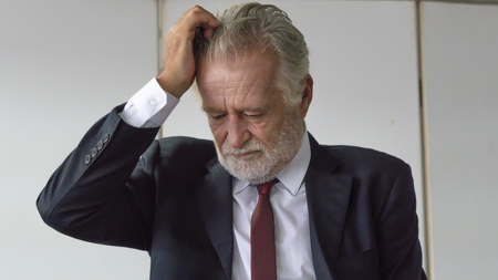 close up face, Senior businessman in smart suit feeling depressedの写真素材