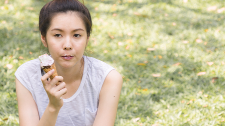 cute girl eat ice cream in close up face feeling deliciousの写真素材