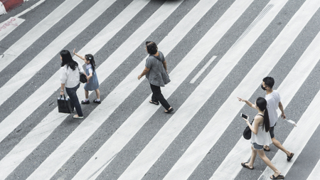 Crowd of people and group of family with child walk on street pedestrian crossroad in the city street ,from top view ,bird eye view.の写真素材