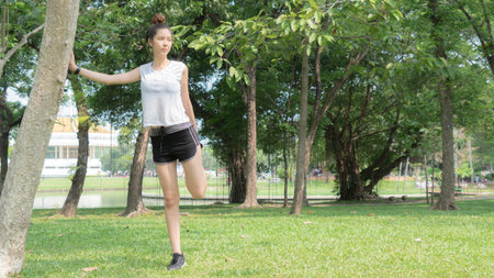 Asian cute healthy fit and firm slim teen lady warm up before workout for weight training or running...