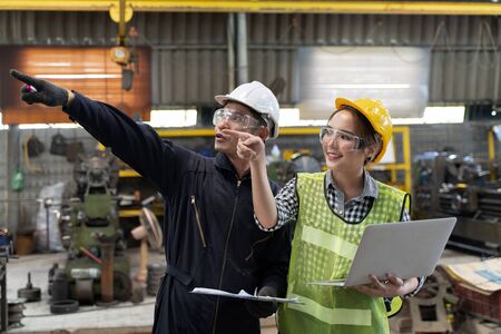 Professional engineering workers walk and check in warehouse factory. Manager discuss inspection report paper for internal audit. Quality assurance for manufacturing. Concept Engineer Operating.の写真素材