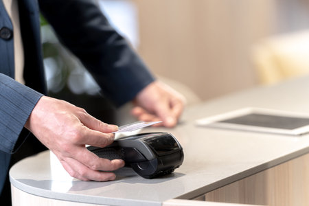 customer hand holding credit card to purchase at counter shop. Concept Contactless payment systems...