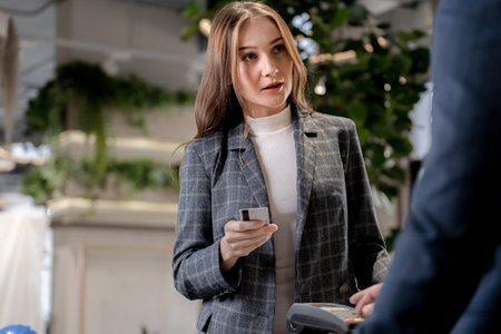 customer woman holding credit card to purchase at counter shop. Concept spending money by credit card.の写真素材