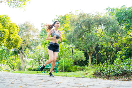 Fitness sport two slim fit and fat girls in fashion sportswear running in garden morning, outdoor sports.の写真素材